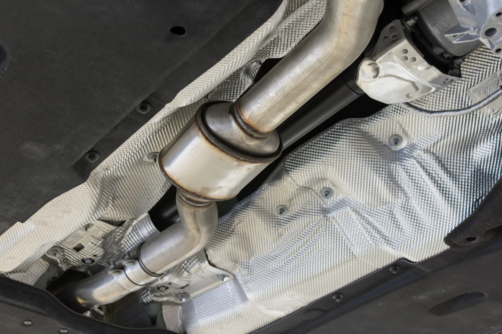 Underbody view of exhaust system showing car catalytic converter